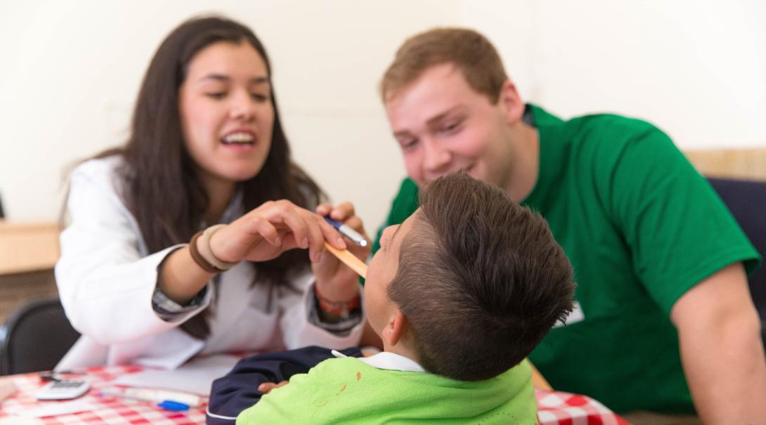 Volunteers give a patient a basic health check during their Medical Project in Mexico. Alternative Spring break volunteers check the health of a young patient in Mexico.